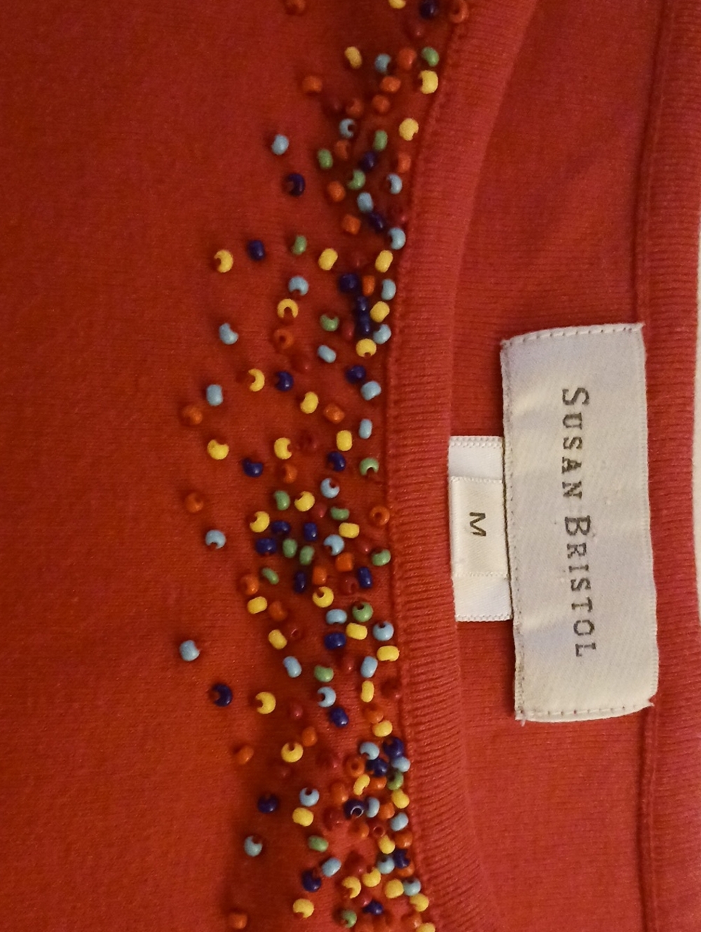 Susan Bristol-size M, color Is coral, tank top with beaded front neckline.